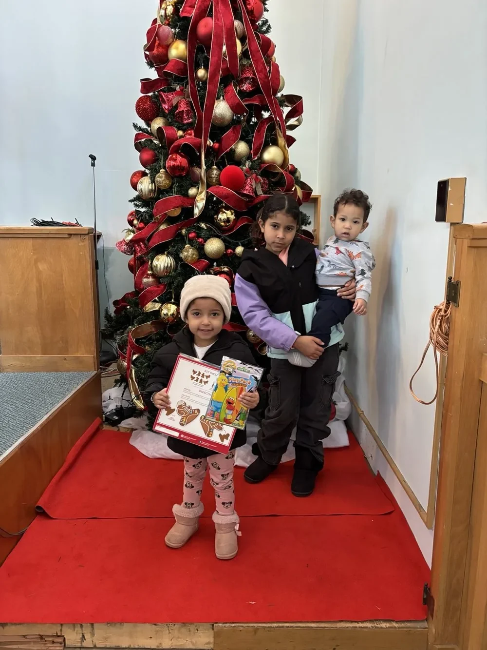 Children sharing a Christmas moment together.