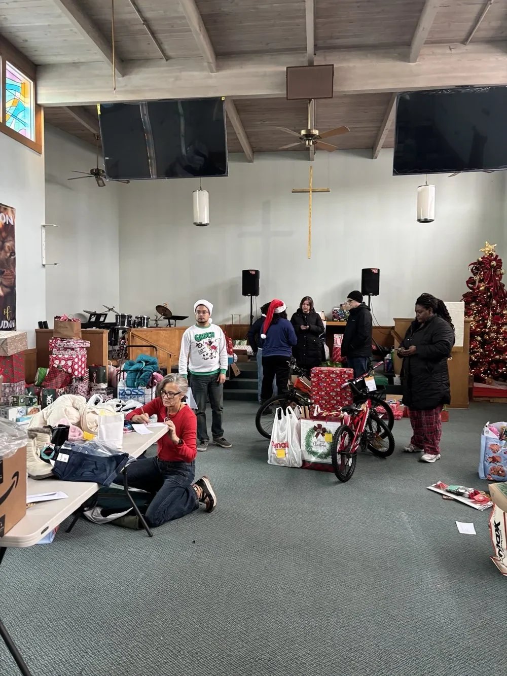 Community members organizing gifts and bicycles.